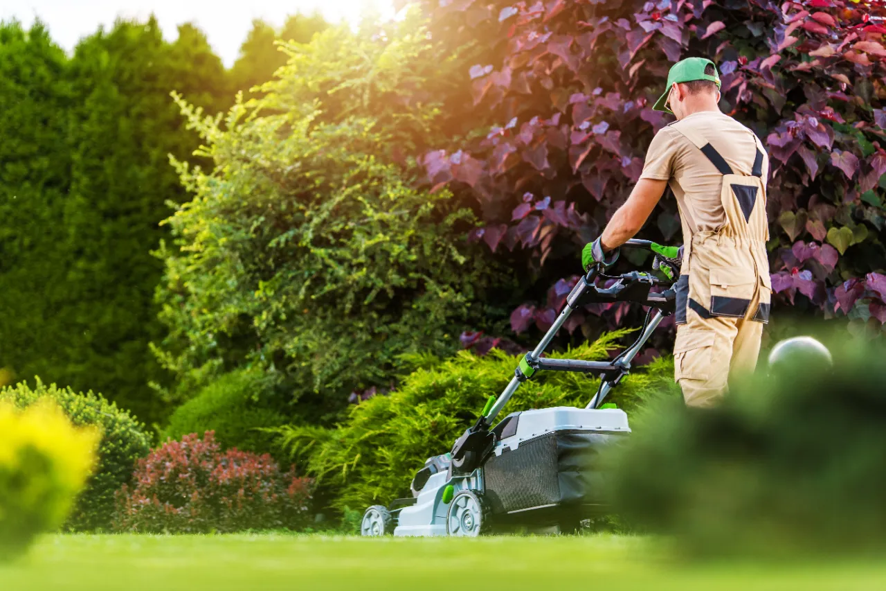 Worker trimming a residential lawn in New Jersey