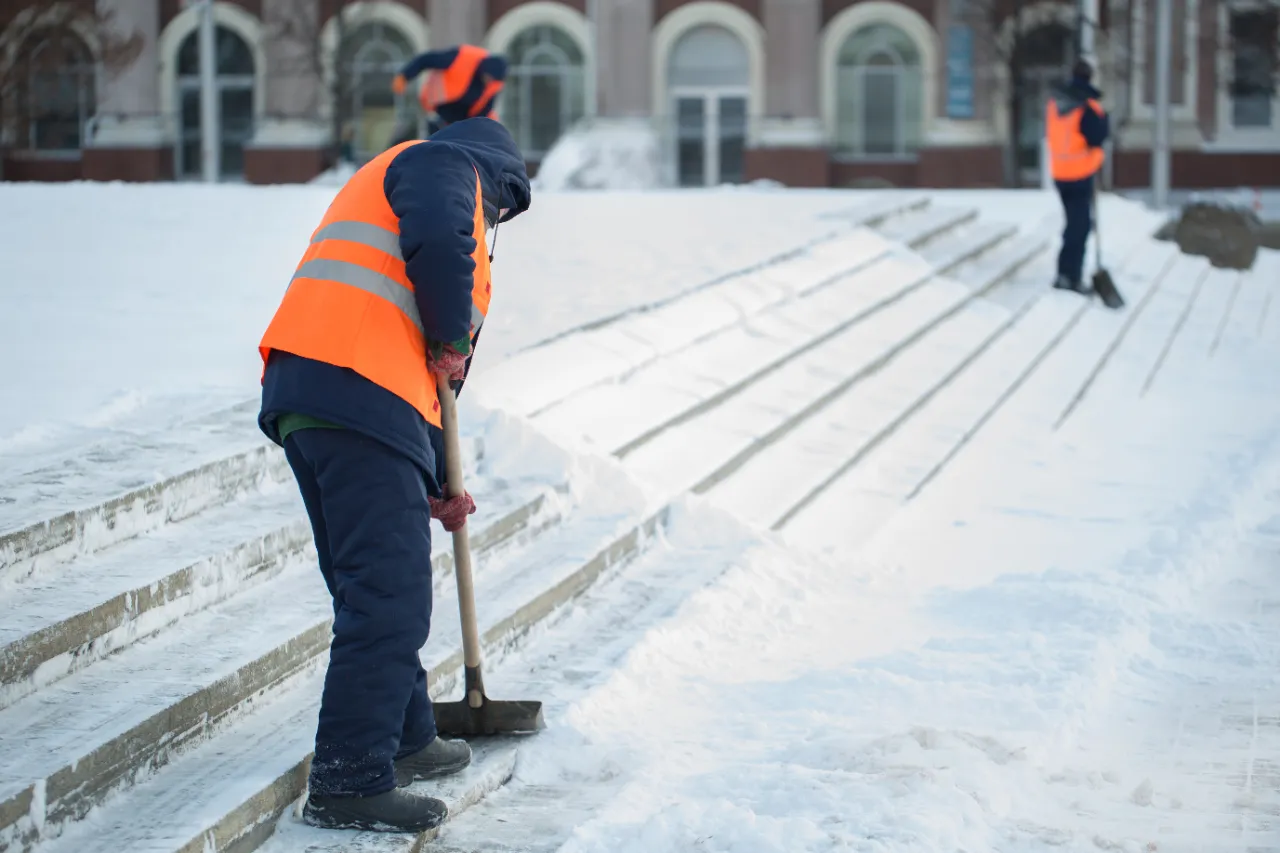 Workers clearing snow from road in New Jersey winter